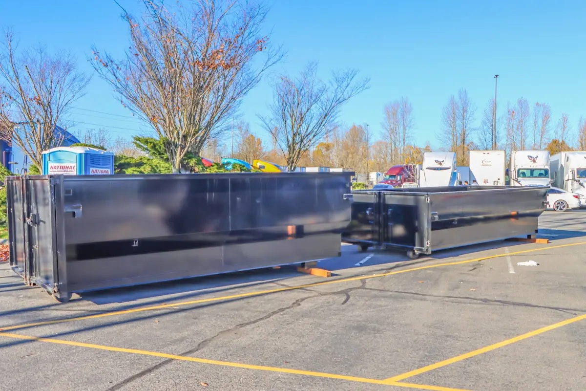 Professional dumpster rental service with roll-off container on residential driveway in Potomac Park